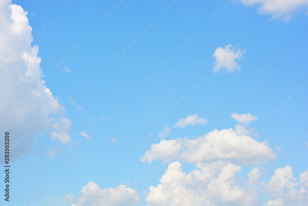 Bright and colorful photos of heavenly angelic white clouds and blue, blue sky with sunlight. Light, delicate and airy cloudy background with white and blue lights and colors.