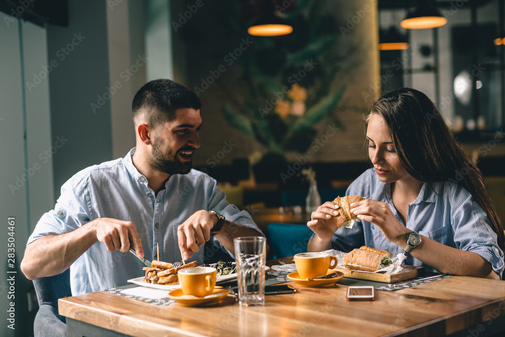 romantic couple having breakfast at snack bar