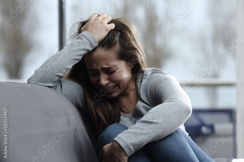 Sad girl complaining and crying at home Fototapet