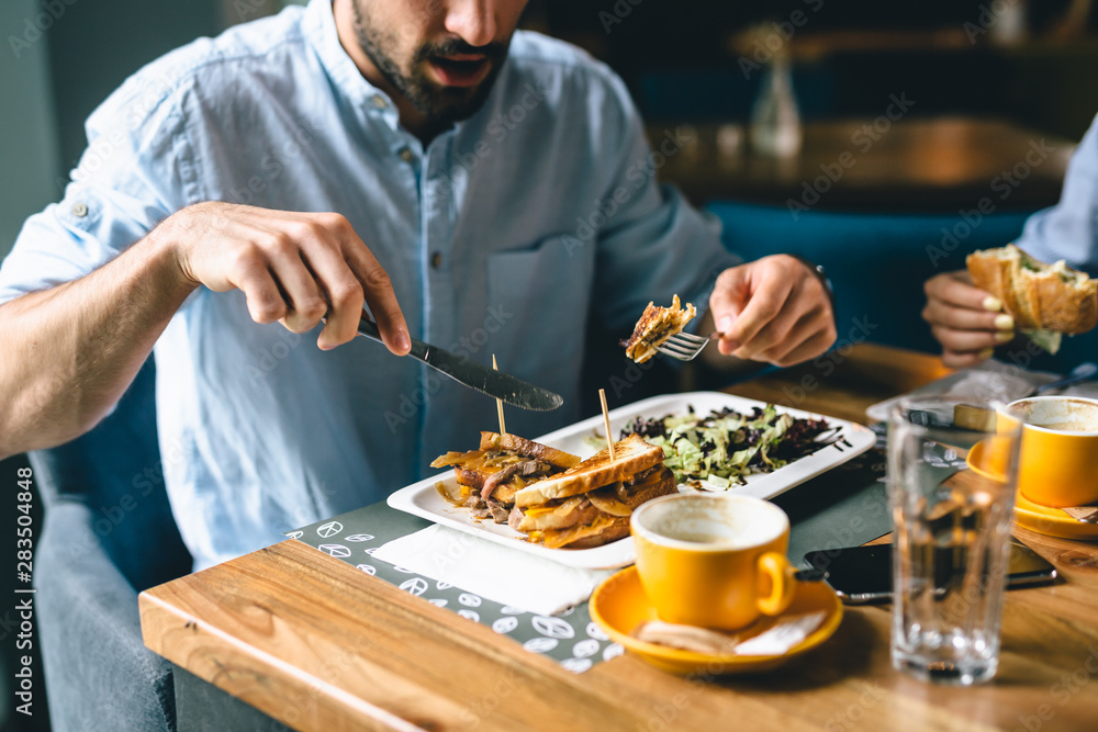 close up shoot of man eating in restaurant close up shoot of man eating in restaurant