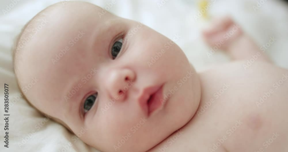 Close-up of sweet little baby face lying in bed Close-up of sweet little baby face lying in bed