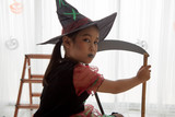 Happy child girl in witch costume to halloween