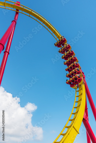 Roller coaster ride under blue sky in theme park