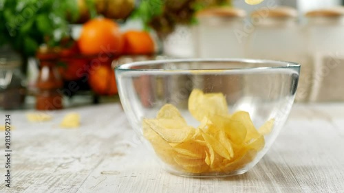 Pouring chips into a bowl. Slow motion.