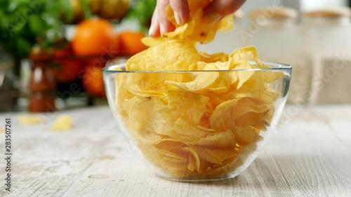 Eating chips from a bowl. Collecting large amounts at once.