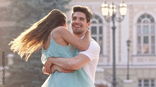 Young happy loving couple walking outdoors at the street having fun