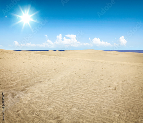 Golden sand and beautiful clear blue sky.