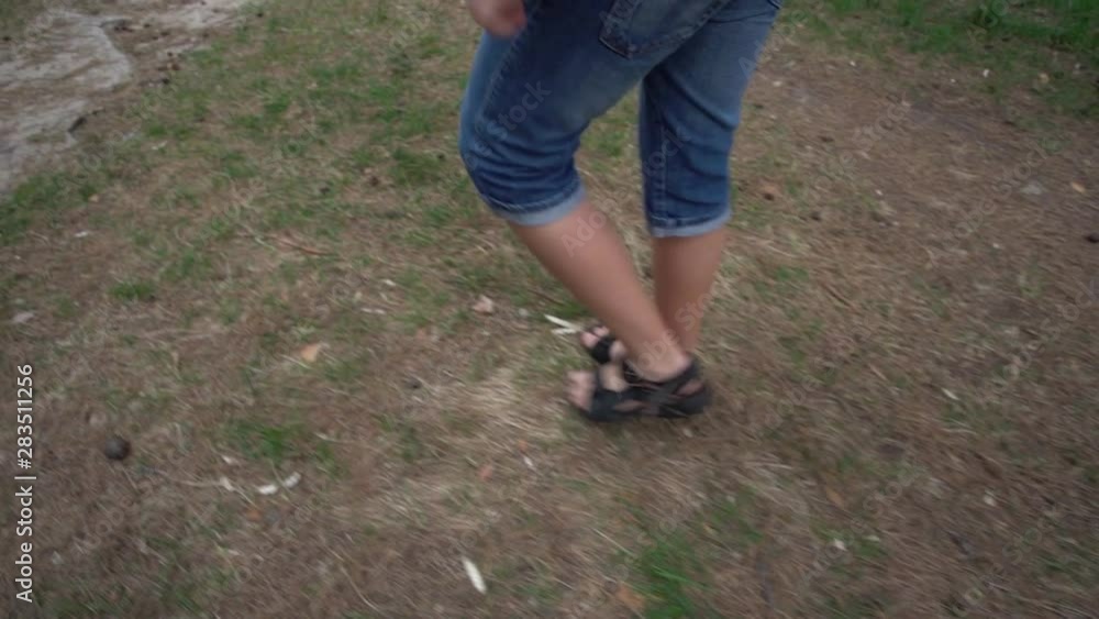 Kids legs walking in spring or summer forest. Real time hd video footage. Kids legs walking in spring or summer forest. Real time hd video footage.