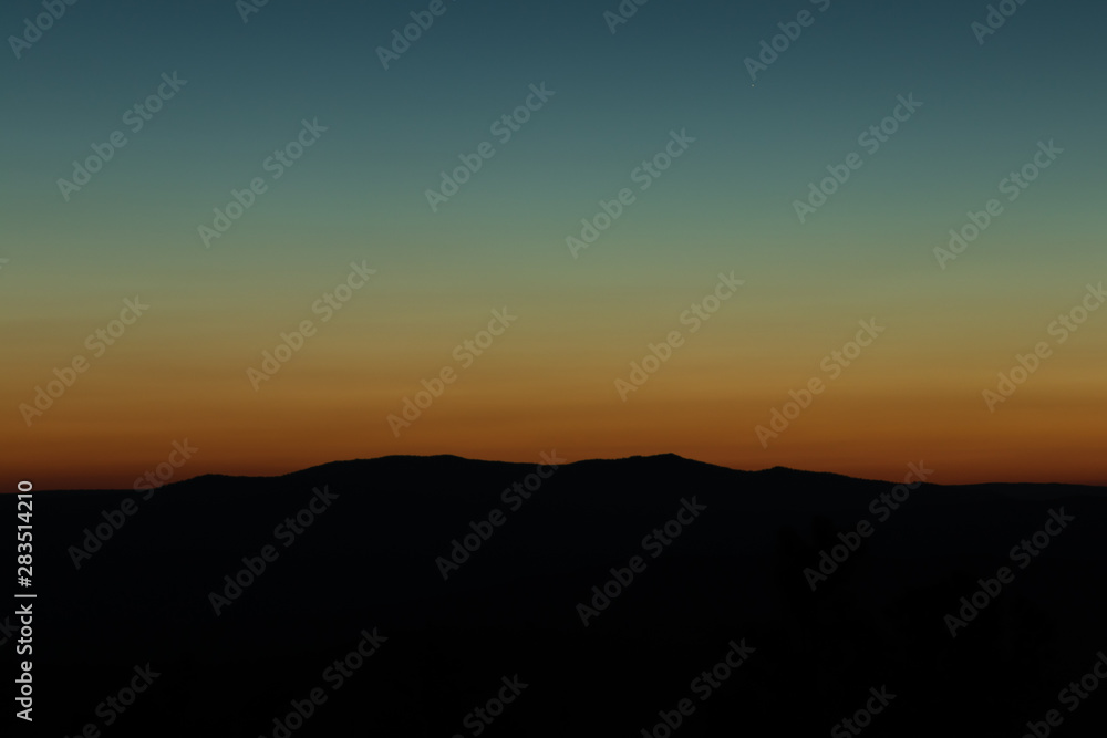 panorama silhouette mountain tops in orange blue gradient sunset panorama silhouette mountain tops in orange blue gradient sunset