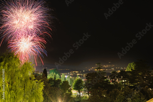 Firework show on Lake Garda, celebration (Sant Ercolano). In the city of Toscolano Maderno Italy. Aerial view.