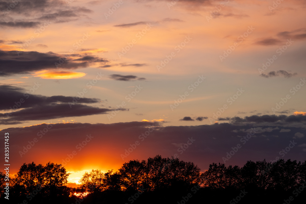 rain clouds and sunbeams at sunset. rain clouds and sunbeams at sunset.