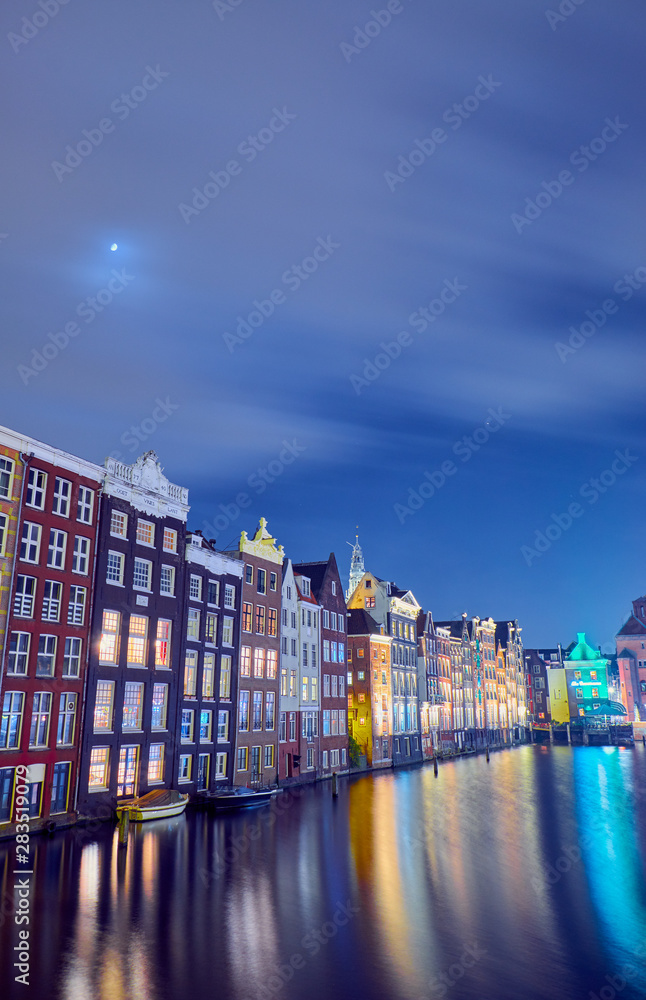 Night cityscape in Amsterdam with old brick houses