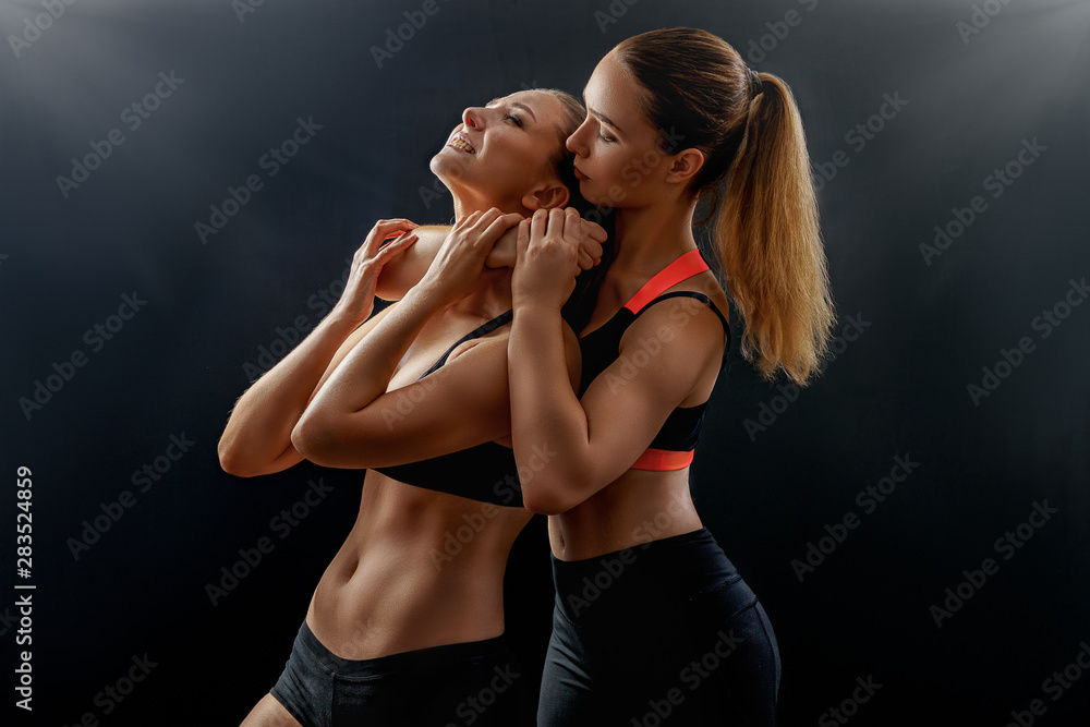 Sexy athletic girl strangles another girl in bra with. Fighting power photo  shoot young female models with beautiful muscles asphyxiation Stock Photo |  Adobe Stock
