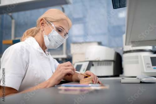 Dental technician making artificial teeth in laboratory. photo