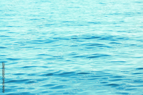 Background texture of a calm surface of the turquoise sea