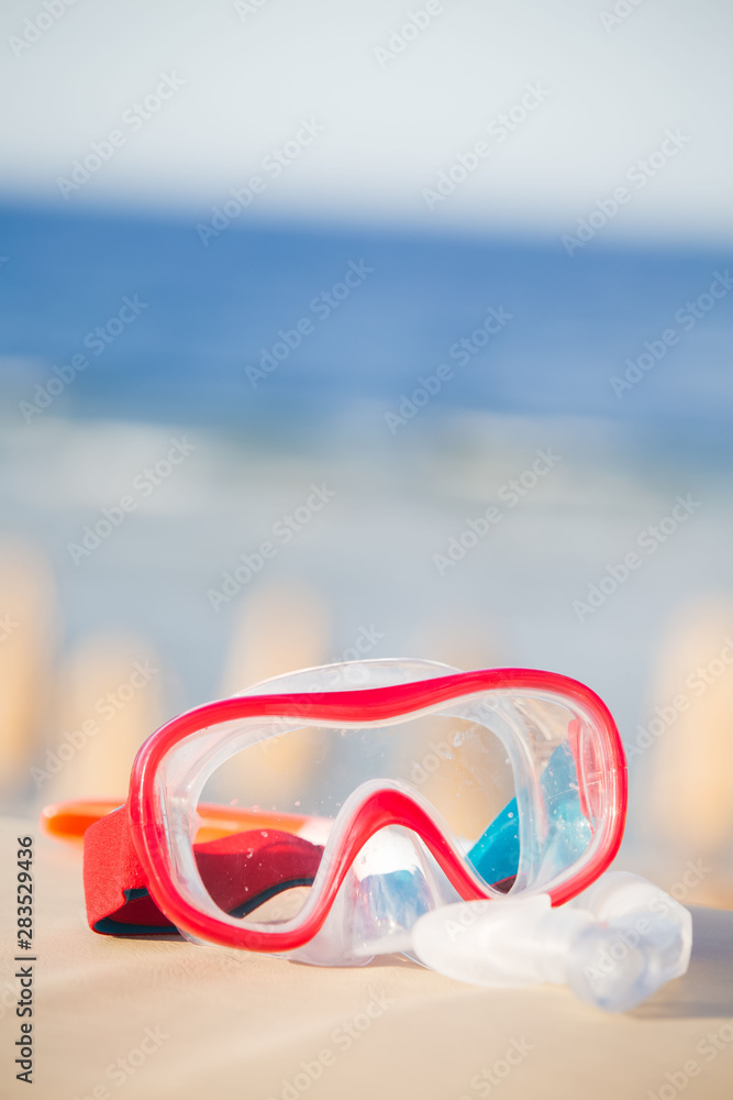 Snorkeling mask and tube on tropical beach