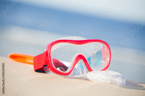 Snorkeling mask and tube on tropical beach