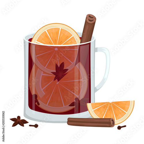 Red mulled wine in a Cup with orange slices, cinnamon, cloves and a tub. Winter alcoholic drink.