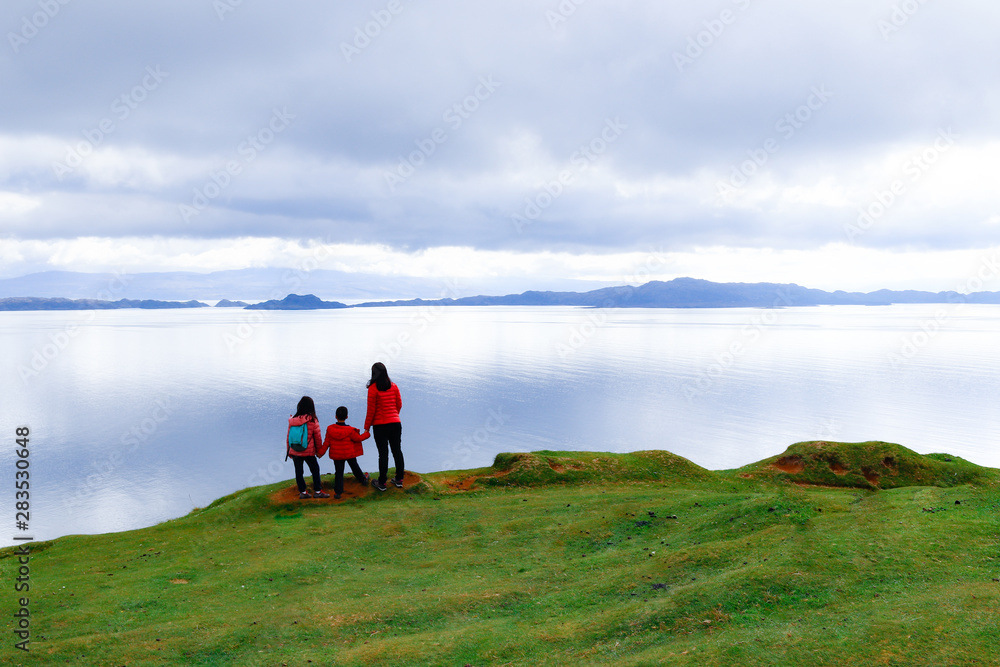 Family enjoying tranquility of nature at Isle of Skye, Scotland