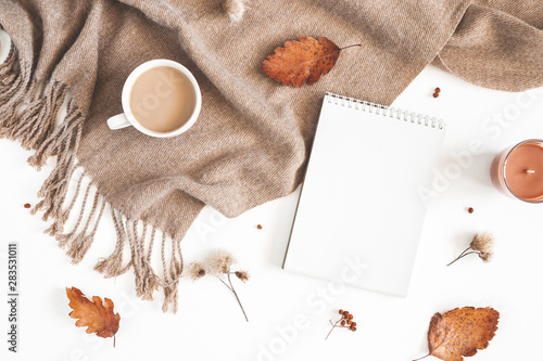 Autumn composition. Cup of coffee, plaid, notepad, autumn leaves on white background. Flat lay, top view, copy space
