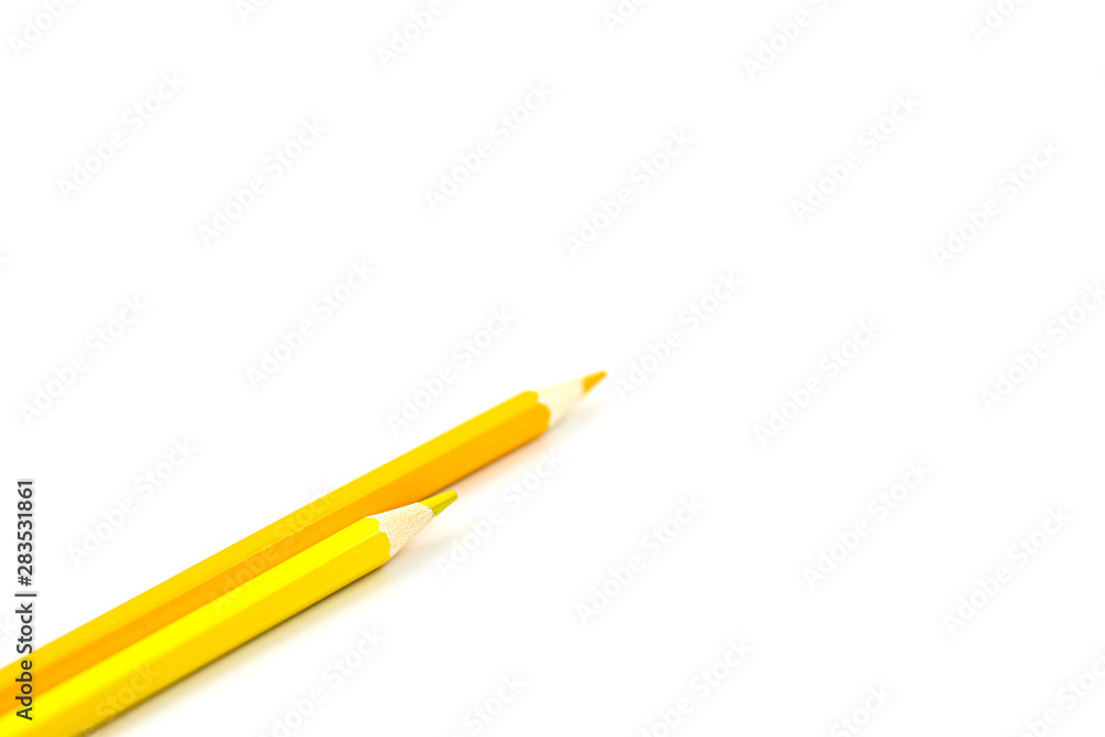 Two yellow pencils on a white background. Selective focus on nearest pencil Two yellow pencils on a white background. Selective focus on nearest pencil