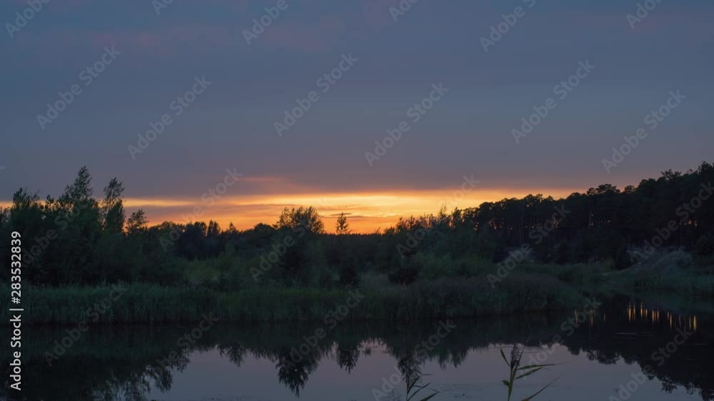 Beautiful sunset over the river with backlighting of the lower layer of clouds, time lapse. Beautiful sunset over the river with backlighting of the lower layer of clouds, time lapse.
