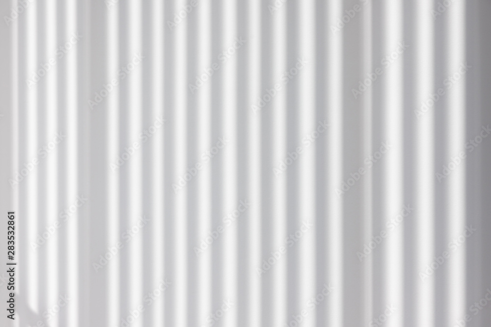 light and striped shadow on white concrete wall. interior design sun protection from wooden batten. house saving energy concept. vertical abstract shadow pattern background. light and striped shadow on white concrete wall. interior design sun protection from wooden batten. house saving energy concept. vertical abstract shadow pattern background.