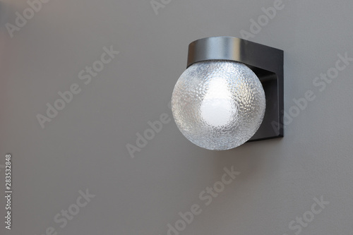 outdoor wall lamp on grey concrete panel. exterior lighting.