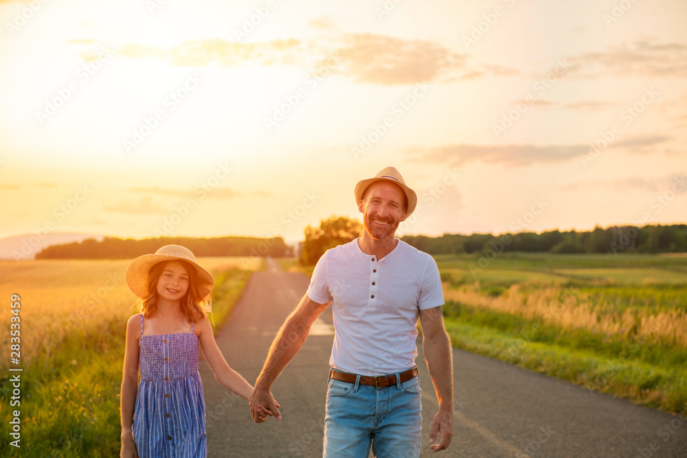 happy family at sunset. father and daughter having fun and playing in nature happy family at sunset. father and daughter having fun and playing in nature