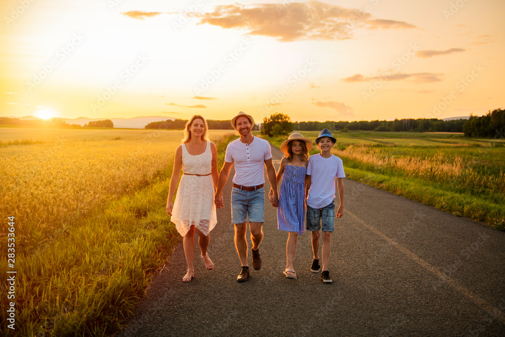 happy family at sunset. They having fun and playing in nature at sunset happy family at sunset. They having fun and playing in nature at sunset