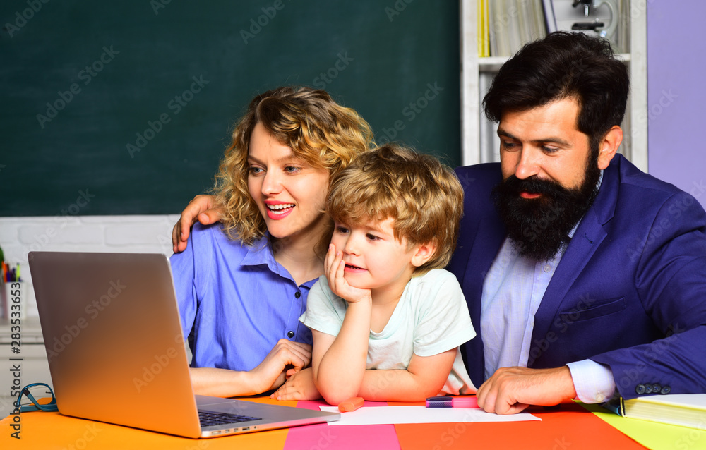 Schoolboy learning letters and numbers with parents. Parents teaching kid private lessons in math. Back to school. Home schooling. Home family schooling. Mathematics for kids. Parents helps child boy. Schoolboy learning letters and numbers with parents. Parents teaching kid private lessons in math. Back to school. Home schooling. Home family schooling. Mathematics for kids. Parents helps child boy.
