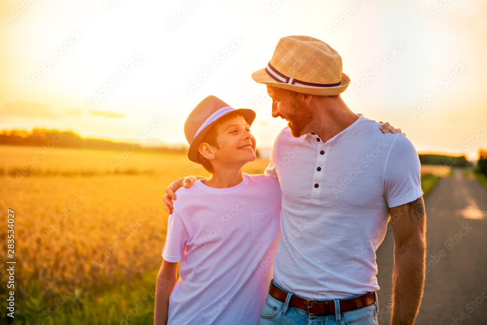 happy family at sunset. father and son having fun and playing in nature