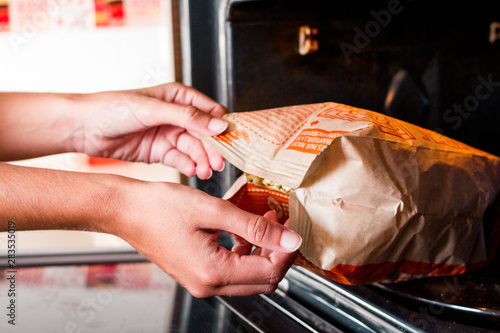 Taking a popcorn bag from the microwave