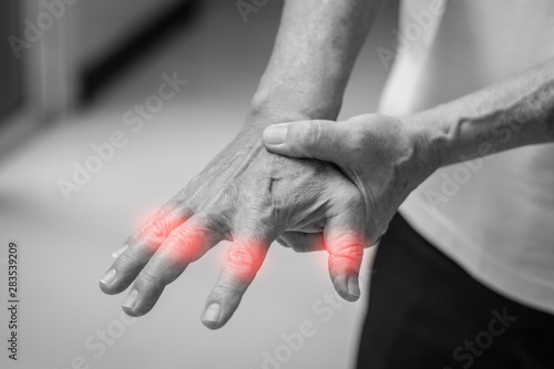 Tendinitis Overuse hand problems. Old man hand with red spot o fingers as suffer from Carpal tunnel syndrome. The symptoms of tingling, numbness, weakness, or pain of the fingers and wrist. photo