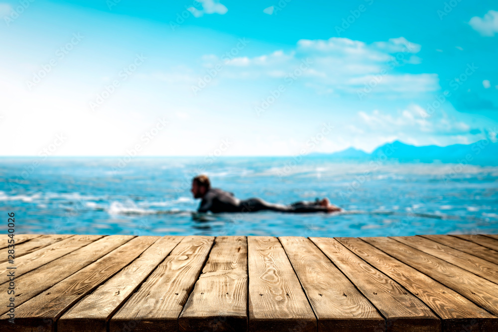 Table background and surfers in the sea view Table background and surfers in the sea view