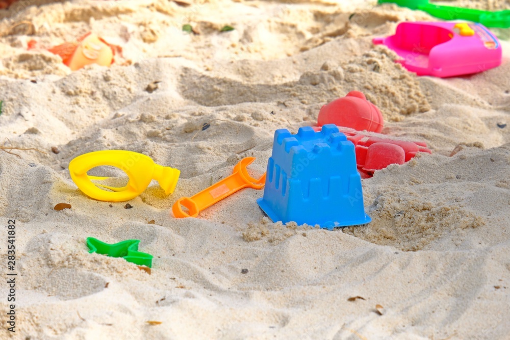 Colorful kids plastic sand toys on sand at the beach. Colorful kids plastic sand toys on sand at the beach.