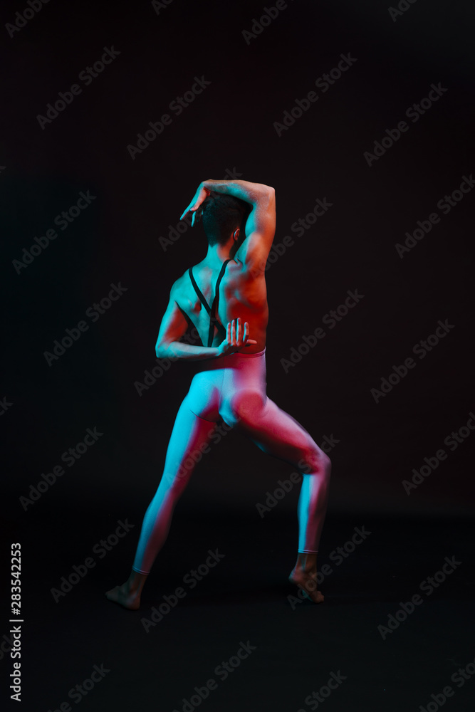 Unrecognizable dancer in leotard performing with arms bent behind back