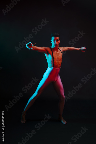 Artistic male in tights dancing