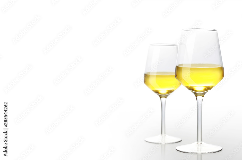 Glass of white wine on a white background