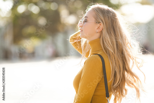 Closeup portrait of young beautiful woman. Female outdoors.