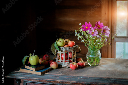 Fototapeta Naklejka Na Ścianę i Meble -  Fresh harvest of ripe and healthy farm apples in a glass jar, in a basket.