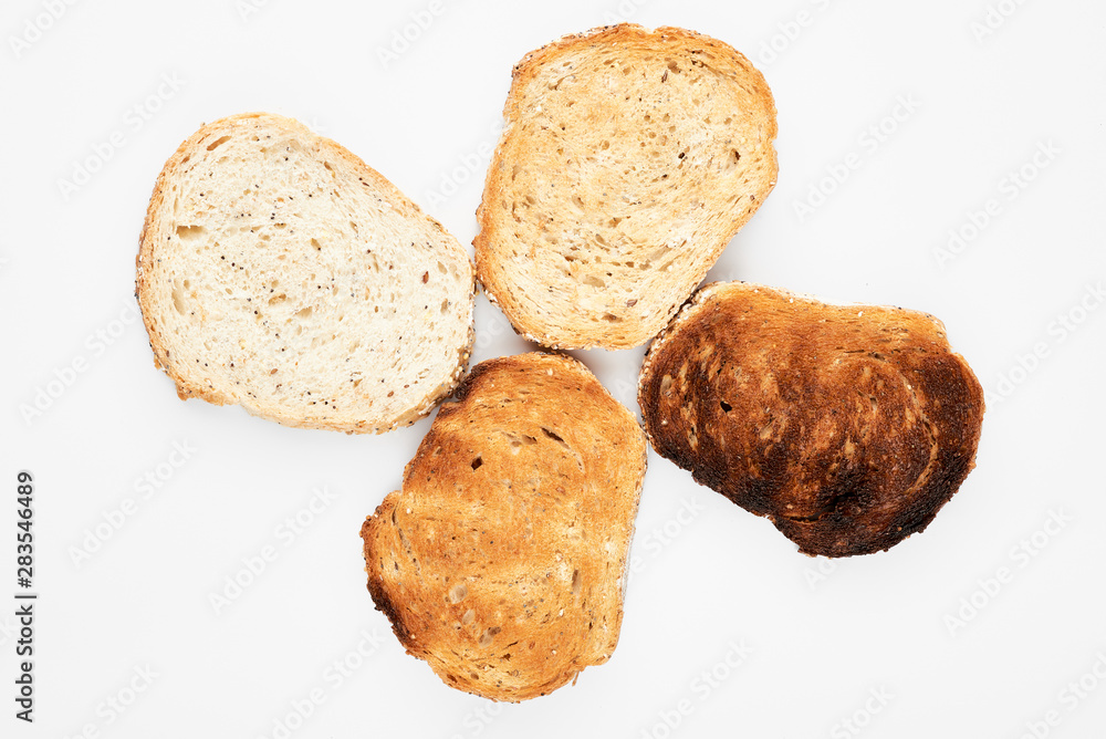 Appetizing slices of bread of different roasting. White background. Appetizing slices of bread of different roasting. White background.