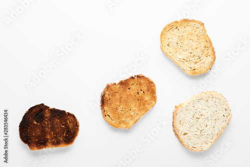 Appetizing slices of fresh bread of different roasts. White background.