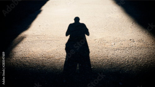 Shadow of a man on a road