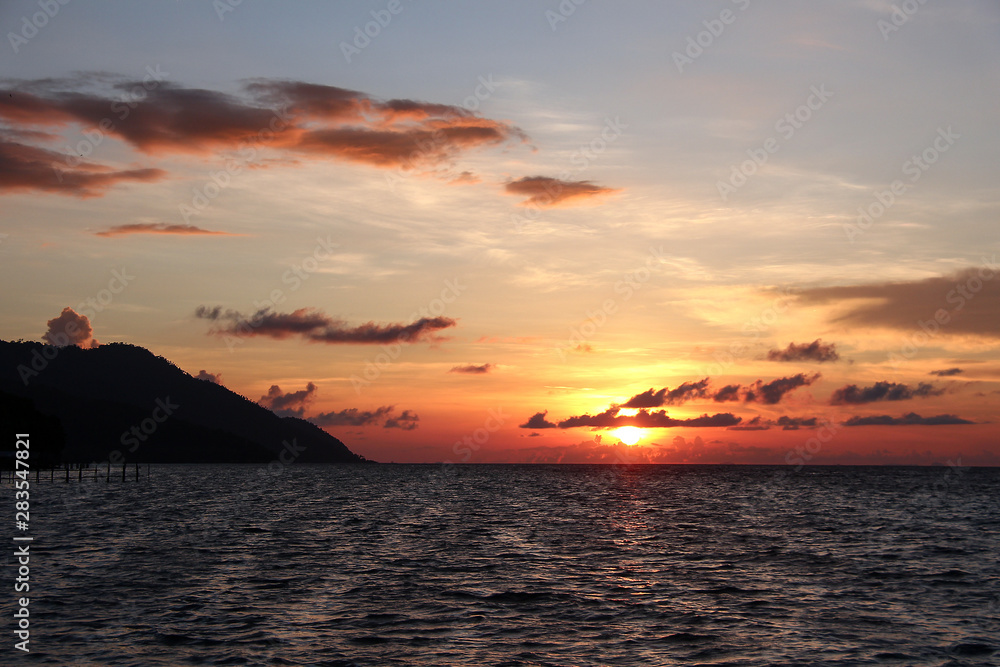 Colorful sunset over the Ocean on Kri Island, Raja Ampat, south-east Asia.