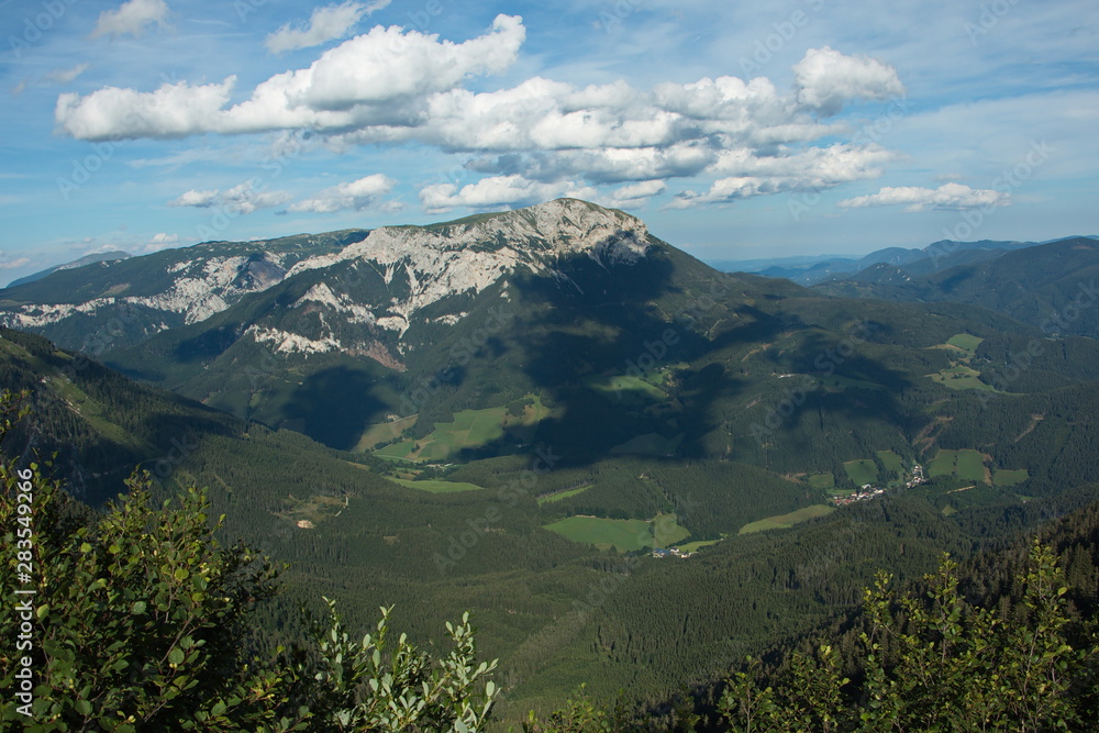 Fototapeta premium Nice clouds above the Heukuppe, the highest mountain of Rax in Lower Austria, Europe