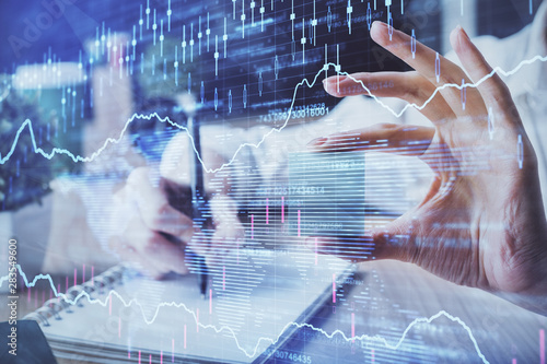 Forex chart displayed on woman's hand taking notes background. Concept of research. Multi exposure