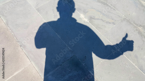 The shadow of a man shows a gesture like