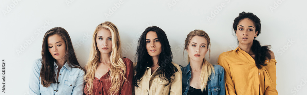 panoramic shot five multiethnic women looking at camera isolated on grey panoramic shot five multiethnic women looking at camera isolated on grey