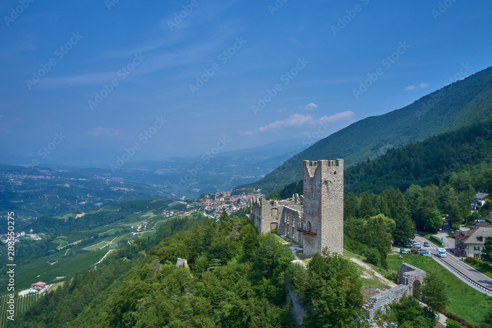 Panoramic view of the Castel Belfort region of Trento north of Italy. The ruins of the castle surrounded by nature. Aerial view.
